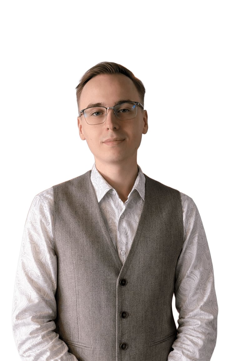 Professional headshot of a man wearing glasses, gray vest, and white shirt against a white background
